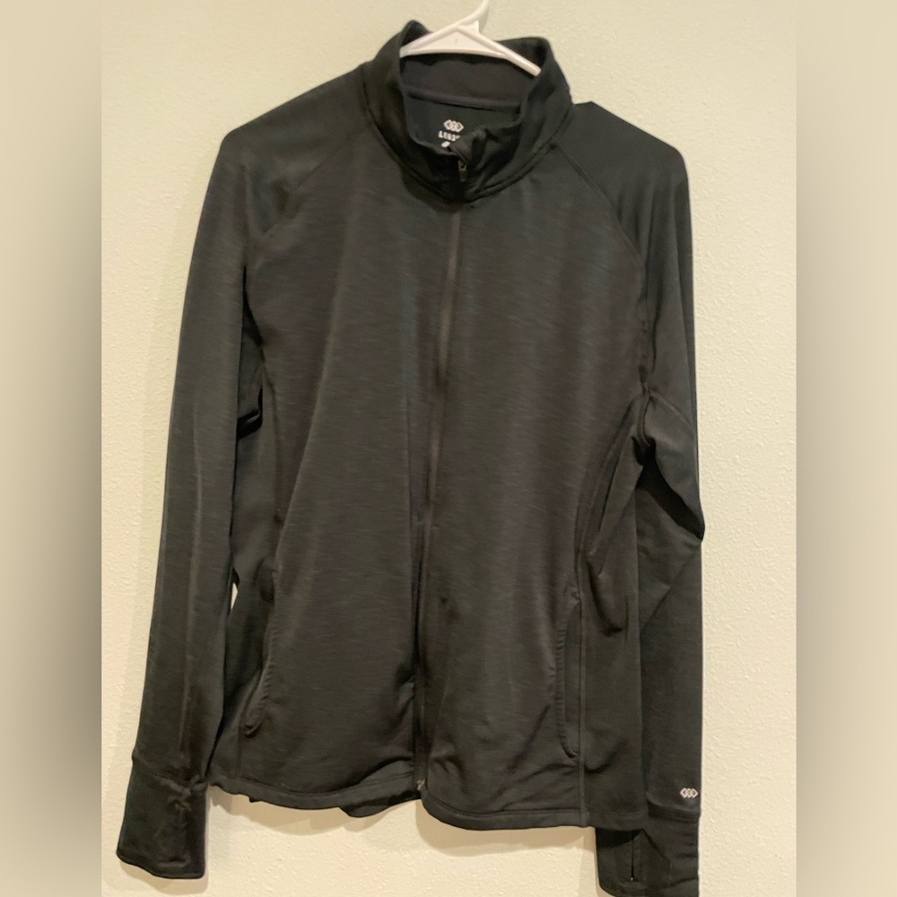 Black Legend zipped activewear jacket with pockets and thumb holes. Size…
